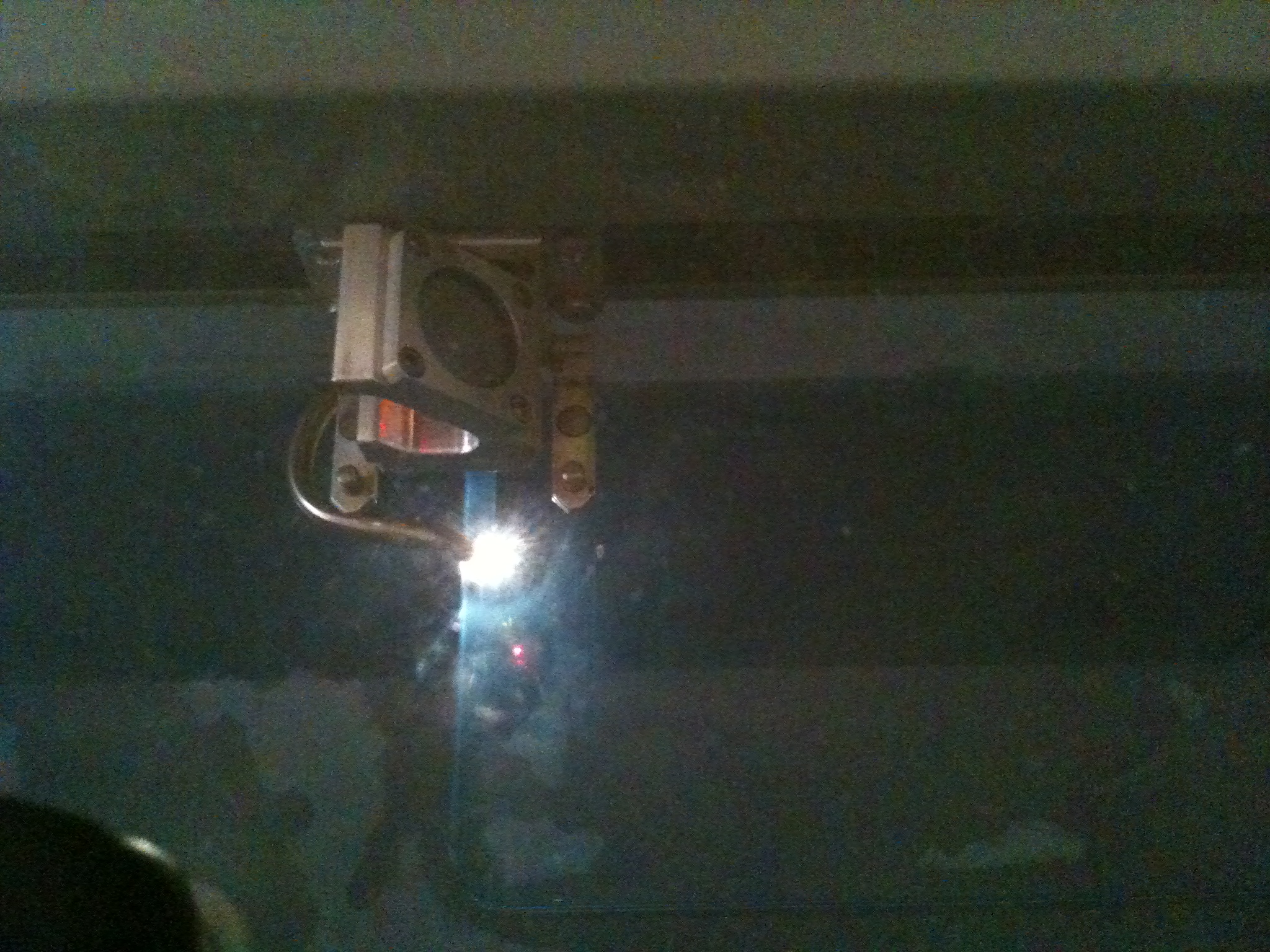 Laser-cut parts sitting in a leftover sheet with the web of unused stock around them