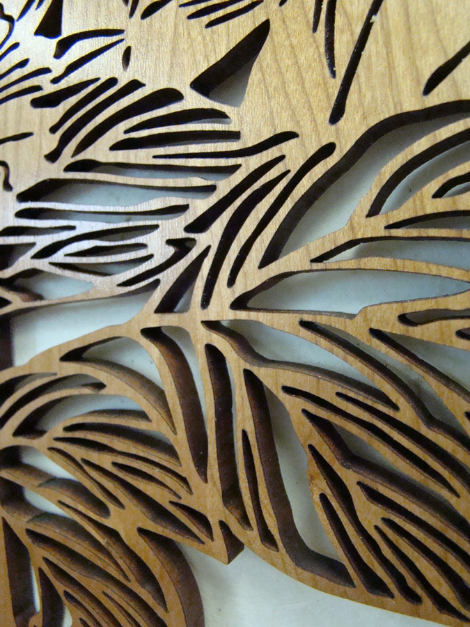 Laser-cut wood panel with narrow slots left between the remaining pieces