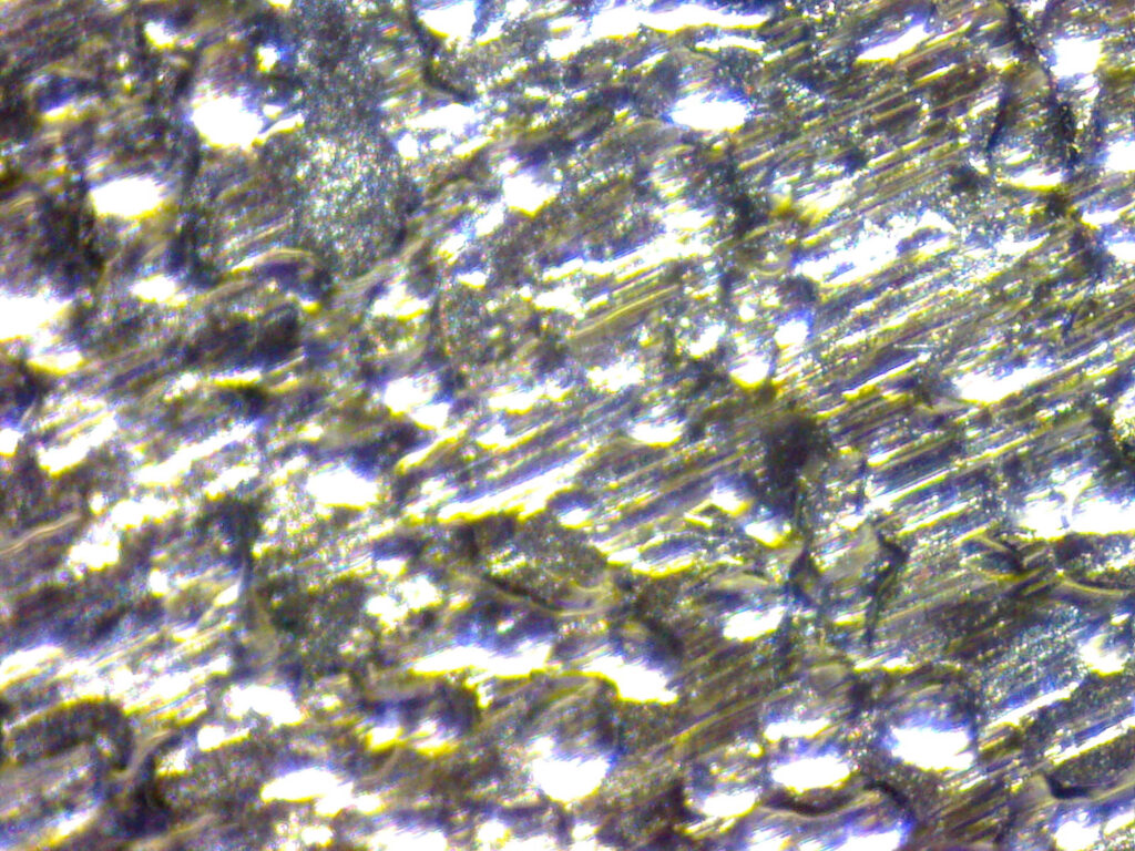 Close-up of a mild steel sheet surface before parts are nested and cut.